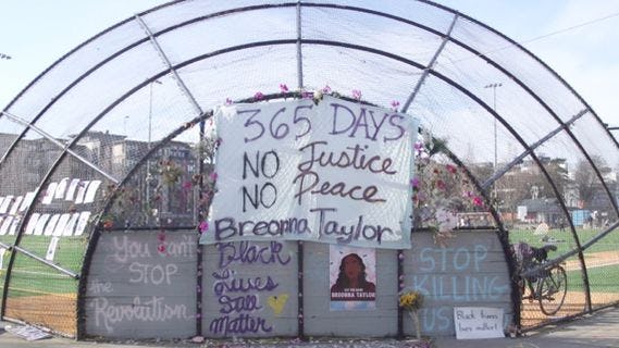A handwritten sign reads 365 Days No Justice No Peace Breonna Taylor